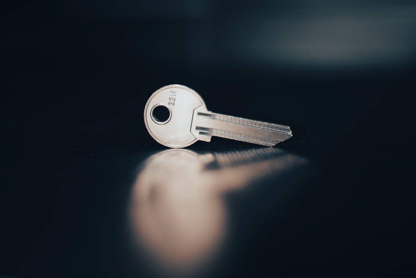 Cut metal key on a dark surface